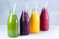 Green, yellow, pink and red smoothie in glass bottles Royalty Free Stock Photo