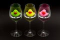 Green, yellow and pink rubber ducks in wineglasses Royalty Free Stock Photo