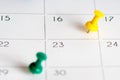 Green yellow pins on calendar grid