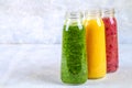 Green, yellow, purple smoothies in bottles of berries, greens, o Royalty Free Stock Photo