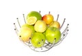 Green yellow red apples and a slice of lemons in a metal decorative basket Royalty Free Stock Photo