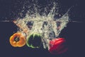 Green Yellow Red bell peppers drop into the water with splash. Royalty Free Stock Photo