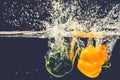 Green Yellow Red bell peppers drop into the water with splash. Royalty Free Stock Photo