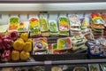 green, yellow, and red bell peppers, onions and mushrooms wrapped in plastic on display in baskets at the Municipal Market Royalty Free Stock Photo