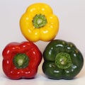 Green, Yellow and Red Fresh Bell Peppers on a White Surface Royalty Free Stock Photo
