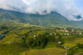 The green and yellow rice terraces at the foot of the green mountains, in Asia, Vietnam, Tonkin, Sapa, towards Lao Cai, in summer Royalty Free Stock Photo