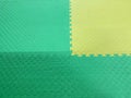 Green and yellow rubber mat for sports and children's playground Royalty Free Stock Photo