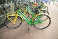 Green yellow street bicycles waiting for tourists to rent them in the Hague