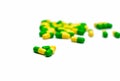 Green, yellow tramadol capsule pills on blurred capsule pills ba
