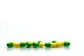 Green, yellow tramadol capsule pills on white background with sh