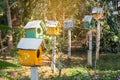 Green and Yellow wooden birdhouse on post in the garden on summer or spring sunshine with natural green leaves background Royalty Free Stock Photo