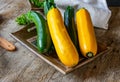 Green and yellow zucchini on wood table Royalty Free Stock Photo
