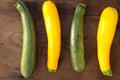 Green and yellow zucchini on wooden background Royalty Free Stock Photo