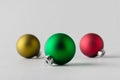 Green, yelow and red Christmas balls on a seamless grey background