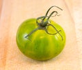 Green Zebra tomato on chopping bord Royalty Free Stock Photo