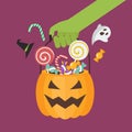 Green zombie hand holding halloween pumpkin basket Royalty Free Stock Photo