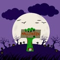 Green zombie monster hand holding HALLOWEEN sign card, out of grave at cemetery graveyard with full moon at dark purple night Royalty Free Stock Photo