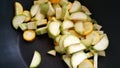 Green zucchini and zucchini in a black wok. Vegan food.