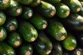 Green zucchini horizontal long fruit stack of vegetables shiny skin background market tray