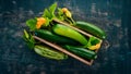 Green zucchini in a wooden box. Fresh vegetables. On a black wooden background. Royalty Free Stock Photo