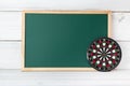 Greenboard with dartboard on white wood background , empty board ,  Target of marketing and  education concept Royalty Free Stock Photo