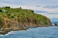 Greened rock at the sea