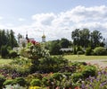 Greenery floral historical monastery garden with colorful spring summer flowers, trees and old church buildings Royalty Free Stock Photo