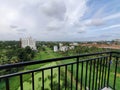 Greenery from highrise apartment building balcony.