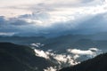 Greenery rainforest hills in foggy day with cloudy sky background Royalty Free Stock Photo