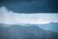 Greenery rainforest hills on rainy day with cloudy sky background Royalty Free Stock Photo