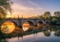 Greenery and trees frame the bridge, indicative of a serene, park-like Royalty Free Stock Photo