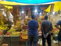 People are standing in front of a fruit stall (Press Photograph)