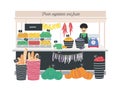 Greengrocer seller standing at counter, stall or kiosk with scales, fruits, vegetables and bread. Grocery shop or store