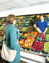 Greengrocer serving a customer Royalty Free Stock Photo