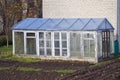 Greenhouse construction in autumn time garden