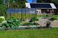 greenhouse and cultivating area infront of barn with solarpanels Royalty Free Stock Photo