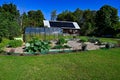 greenhouse and cultivating area infront of barn with solarpanels Royalty Free Stock Photo