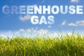 Greenhouse gas emissiones concept image against a green wild grass on sky background Royalty Free Stock Photo