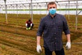 Greenhouse owner in medical mask