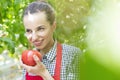 Smiling farmer holding fresh organic tomato in greenhouse Royalty Free Stock Photo