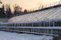 Greenhouse snow removal after snowfall in wintertime. Hothouse roof with icicles hanging from edges