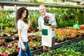 Greenhouse worker giving plants to a customer Royalty Free Stock Photo