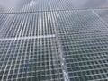 Greenhouses aerial view, drone view on industrial modern glasshouse. Green plantations shot through the transparent glass ceiling