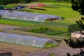 Greenhouses surrounded by green fields in Pamplona, Spain