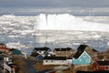 Greenland glacier glaciers houses ocean small town burg sky