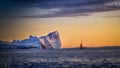 Greenland Ilulissat glaciers at ocean with red sailing boat
