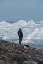 Greenland tourist man explorer overlooking Icefjord in Ilulissat. Travel in arctic landscape nature with icebergs Royalty Free Stock Photo