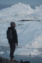 Greenland tourist man explorer overlooking Icefjord in Ilulissat. Travel in arctic landscape nature with icebergs Royalty Free Stock Photo