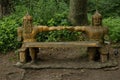 Greenman sculpture setting in forest dappled with sun and shade at Renassiance Festiva