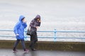 Greenock, Inverclyde, Scotland, UK, October 2nd 2021, Elderly women walking in heavy rain during British wet summer UK